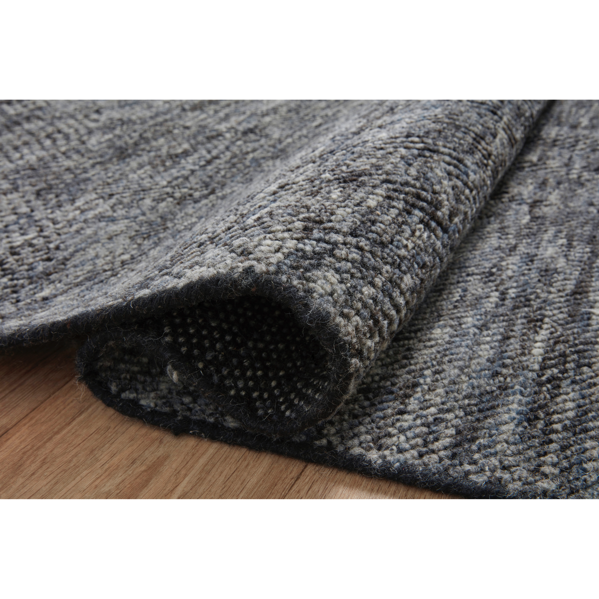 The Collins Amber Lewis x Loloi COI-01 AL Charcoal / Denim rug for Amber Lewis x Loloi is hand-knotted of wool and cotton by skilled artisans in India and GoodWeave-Certified. Collins features varying knotting techniques interwoven to create a uniquely texture pattern. Amethyst Home provides interior design, new construction, custom furniture, and rugs for the Calabasas and Los Angeles metro area.