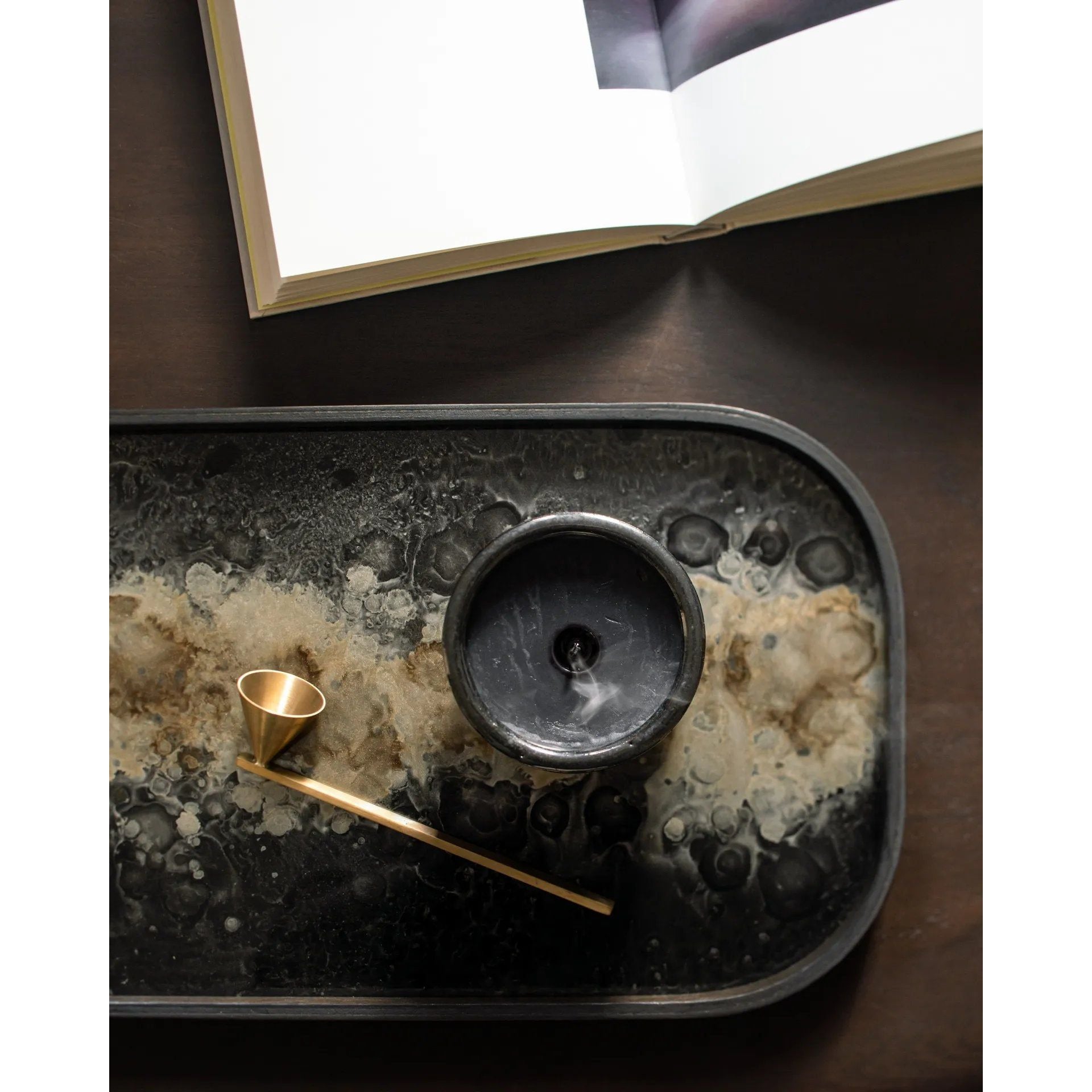 A subdued color palette meets captivating motifs inspired by nature and travel. This Black Organic glass valet tray experiments with the balance between rich patterns offset with muted tones, revealing the beauty behind the deceivingly ordinary subjects from which inspiration is drawn. Amethyst Home provides interior design, new home construction design consulting, vintage area rugs, and lighting in the Boston metro area.