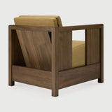 The Roan lounge chair is based on a 1930s original by Paul Poiret, reinterpreted in a form that feels steady and composed. A solid wooden frame surrounds a generous seat, creating a compact chair with a grounded stance. Defined by clean lines and structured arms, Roan offers comfort without excess. Amethyst Home provides interior design, new home construction design consulting, vintage area rugs, and lighting in the Alpharetta metro area.