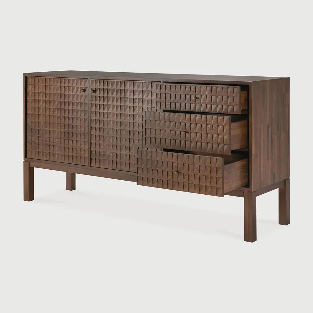 Sono, where antique-inspired craftsmanship meets modern elegance. This refined statement collection features hand-carved panels, offering functional storage behind classic beauty. Delicate casted brass handles elevate its look, making for a stunning addition to a room. Amethyst Home provides interior design, new home construction design consulting, vintage area rugs, and lighting in the Boston metro area.