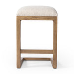 'A stunner from every angle, this architecturally inspired counter stool features an angular base crafted from solid ash with two iron rods for added support and visual interest. Seat is upholstered in a linen/cotton/poly blend performance fabric with subtle texture throughout. Amethyst Home provides interior design, new construction, custom furniture, and area rugs in the Dallas metro area