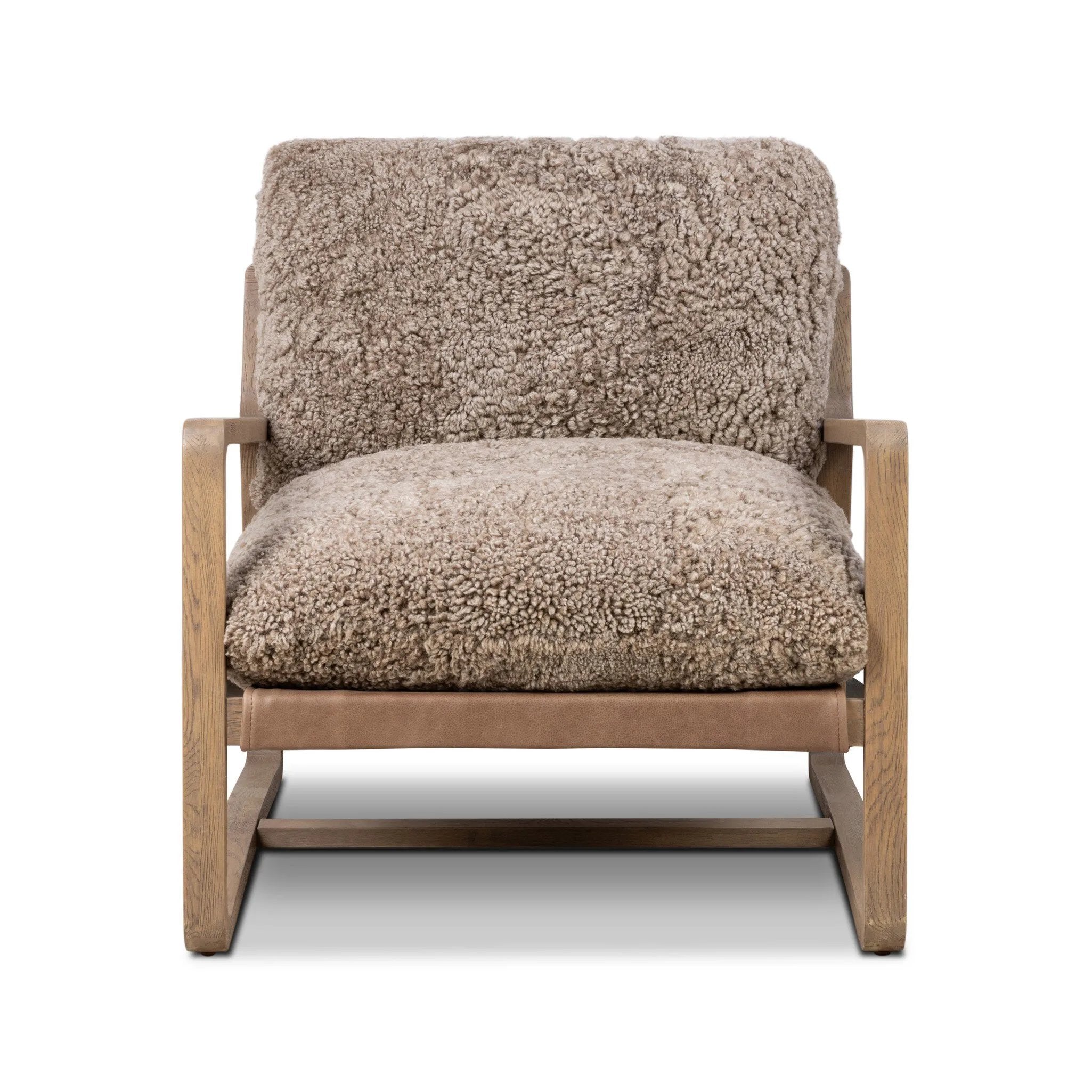 The perfect place to curl up with a good book. A hand-shaped parawood frame supports low, deep seating upholstered with taupe shearling Amethyst Home provides interior design, new home construction design consulting, vintage area rugs, and lighting in the Austin metro area.