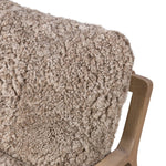 The perfect place to curl up with a good book. A hand-shaped parawood frame supports low, deep seating upholstered with taupe shearling Amethyst Home provides interior design, new home construction design consulting, vintage area rugs, and lighting in the Omaha metro area.