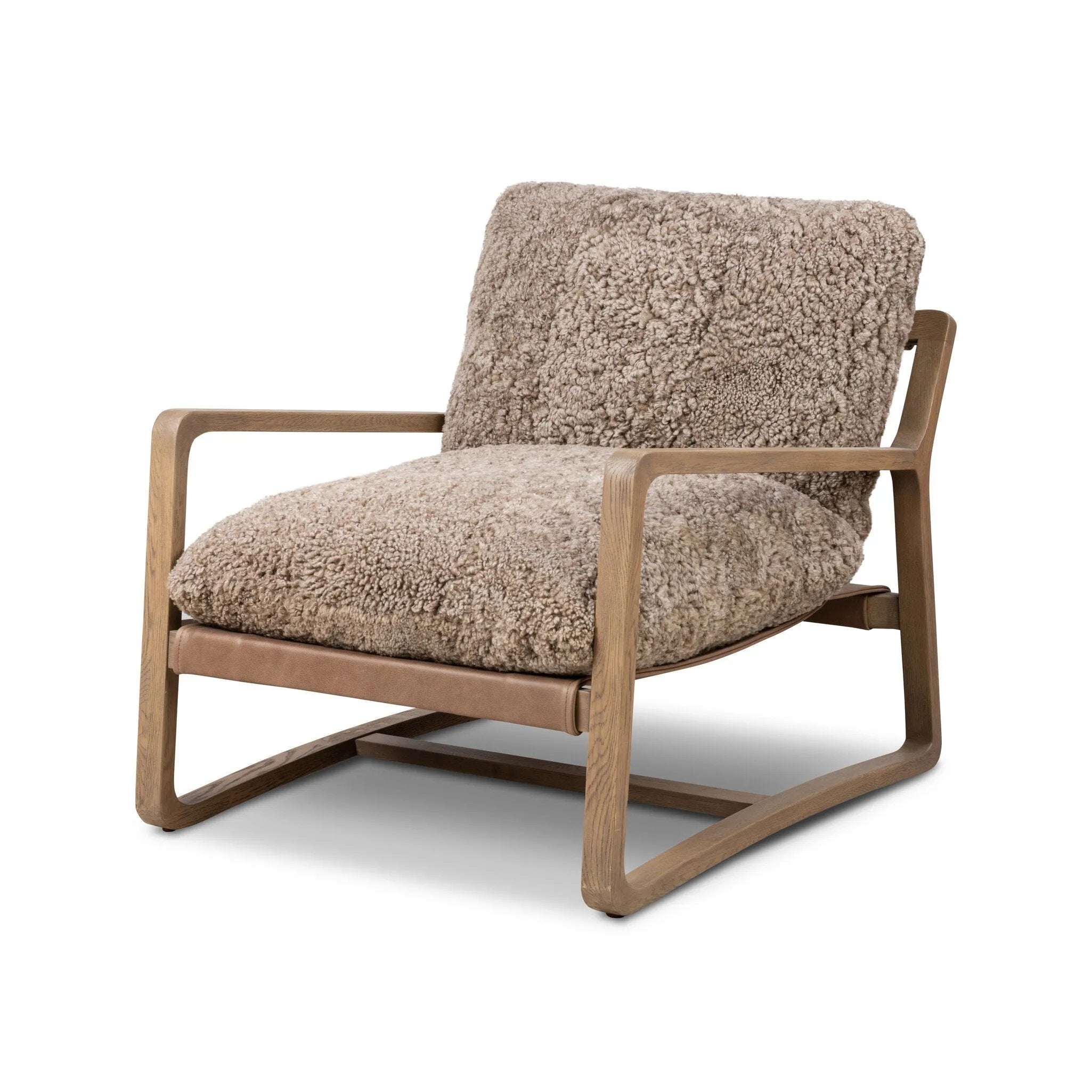 The perfect place to curl up with a good book. A hand-shaped parawood frame supports low, deep seating upholstered with taupe shearling Amethyst Home provides interior design, new home construction design consulting, vintage area rugs, and lighting in the Salt Lake City metro area.