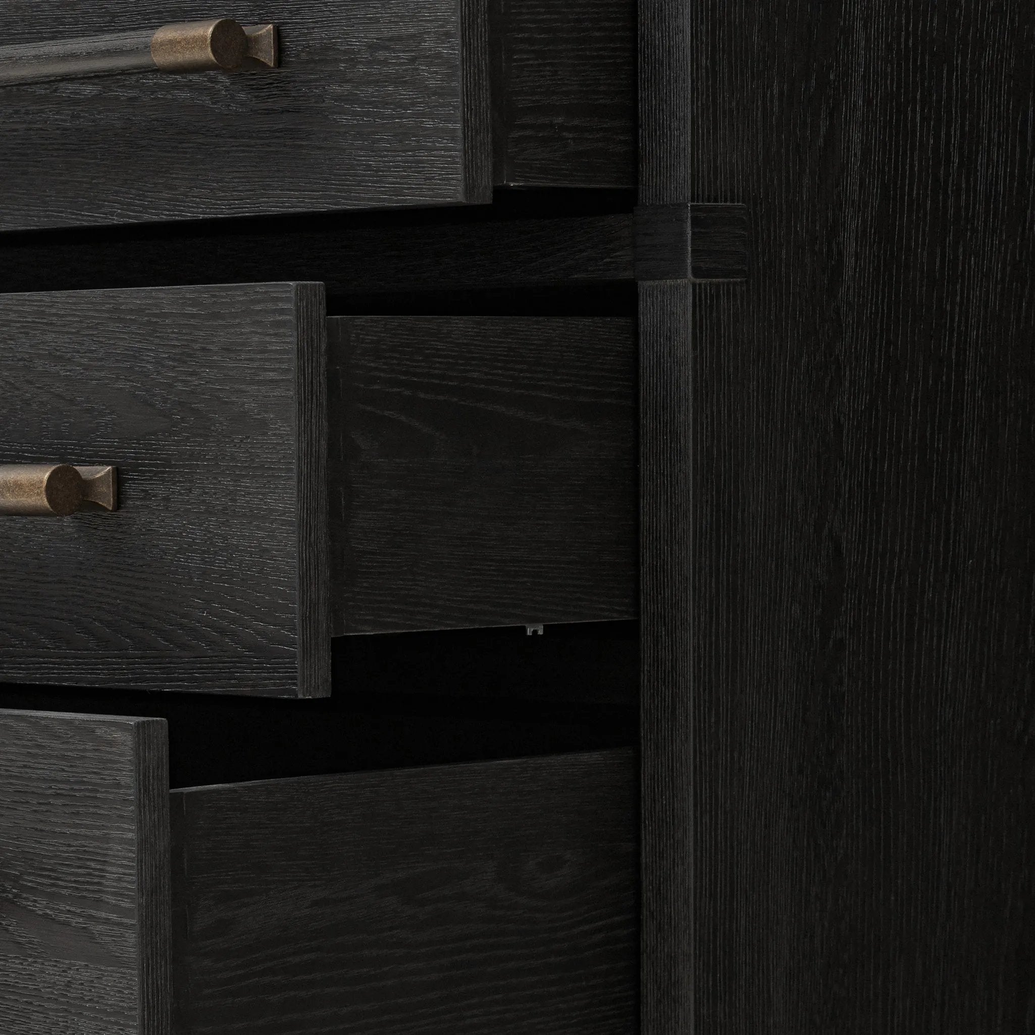 Beautifully minimalist. A three-drawer dresser made from black-finished ash  features long, linear bronzed hardware for a smooth, clean look Amethyst Home provides interior design, new home construction design consulting, vintage area rugs, and lighting in the Boston metro area.