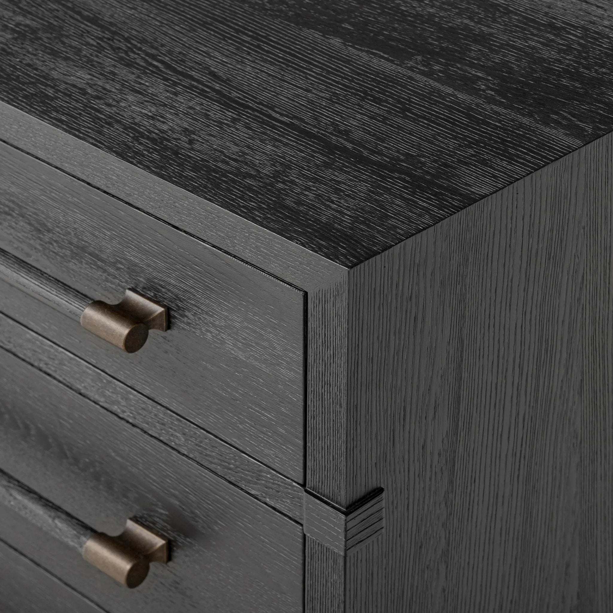 Beautifully minimalist. A three-drawer dresser made from black-finished ash  features long, linear bronzed hardware for a smooth, clean look Amethyst Home provides interior design, new home construction design consulting, vintage area rugs, and lighting in the Monterey metro area.