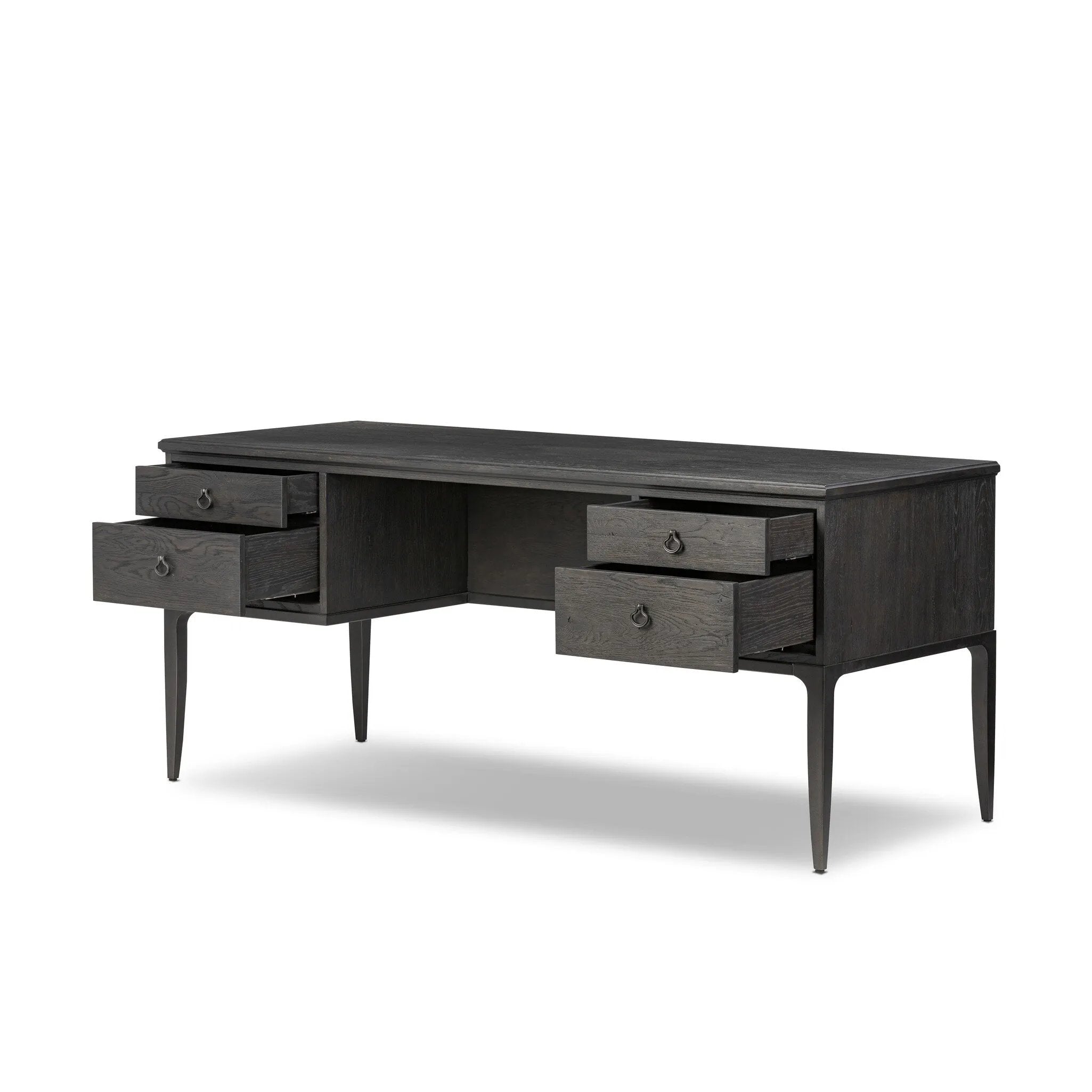 Baroque-period detailing gives this oak desk its  classic look. Made from worn black oak with metal ring pulls on its four drawers, as well as cabriole-like legs to soften the lines Amethyst Home provides interior design, new home construction design consulting, vintage area rugs, and lighting in the Miami metro area.