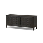 A transitional piece that works into your collection with ease. This solid oak sideboard is finished in a smoked black, highlighting natural graining inherent to rich character woods. Grid-like patterned doors bring dimension to clean, simple shaping, while interior shelving awaits storage of dinnerware, table linens and more. Amethyst Home provides interior design, new home construction design consulting, vintage area rugs, and lighting in the Laguna Beach metro area.
