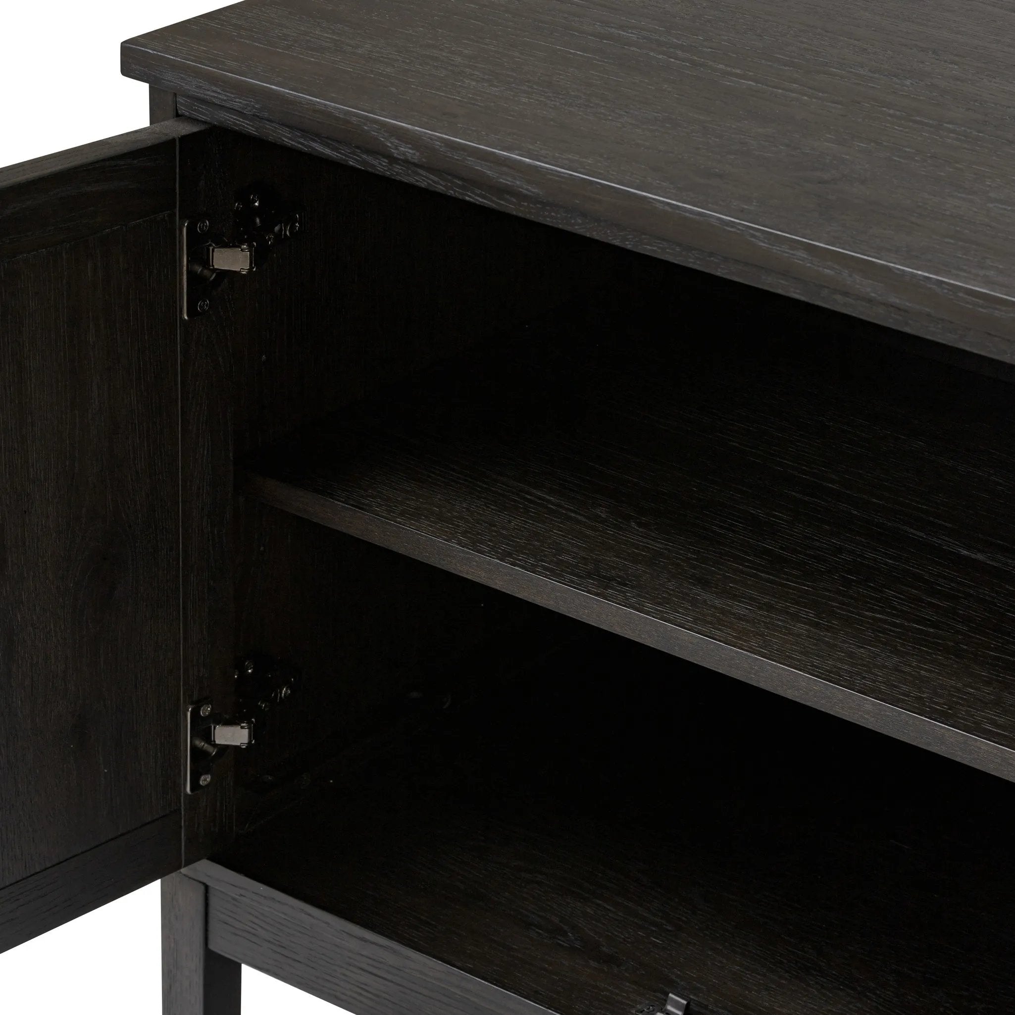 A transitional piece that works into your collection with ease. This solid oak sideboard is finished in a smoked black, highlighting natural graining inherent to rich character woods. Grid-like patterned doors bring dimension to clean, simple shaping, while interior shelving awaits storage of dinnerware, table linens and more. Amethyst Home provides interior design, new home construction design consulting, vintage area rugs, and lighting in the Winter Garden metro area.