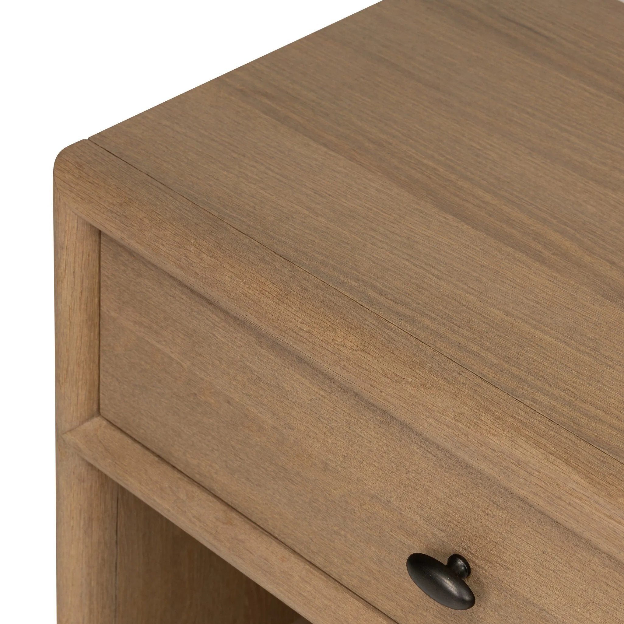 Crafted from sandy solid oak in a waterfall silhouette, this nightstand adds a touch of contemporary simplicity to the bedside. Stack your favorite books on a spacious bottom shelf. The piece’s bullnose edge and oval iron drawer pull add variety. Amethyst Home provides interior design, new home construction design consulting, vintage area rugs, and lighting in the Austin metro area.