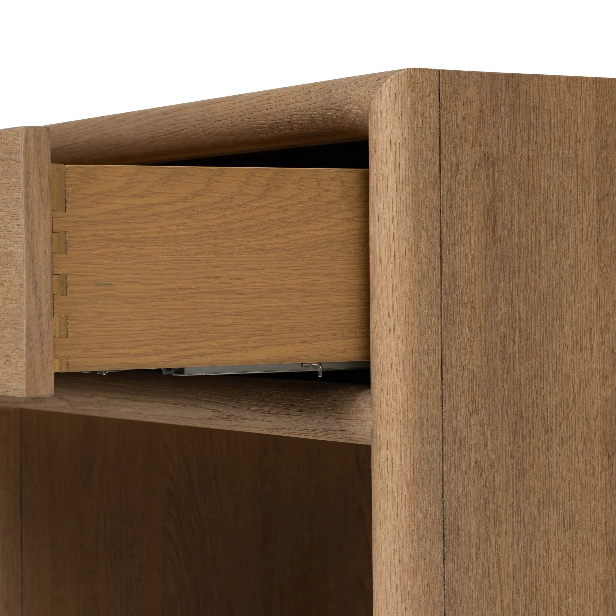 Crafted from sandy solid oak in a waterfall silhouette, this nightstand adds a touch of contemporary simplicity to the bedside. Stack your favorite books on a spacious bottom shelf. The piece’s bullnose edge and oval iron drawer pull add variety. Amethyst Home provides interior design, new home construction design consulting, vintage area rugs, and lighting in the Charlotte metro area.