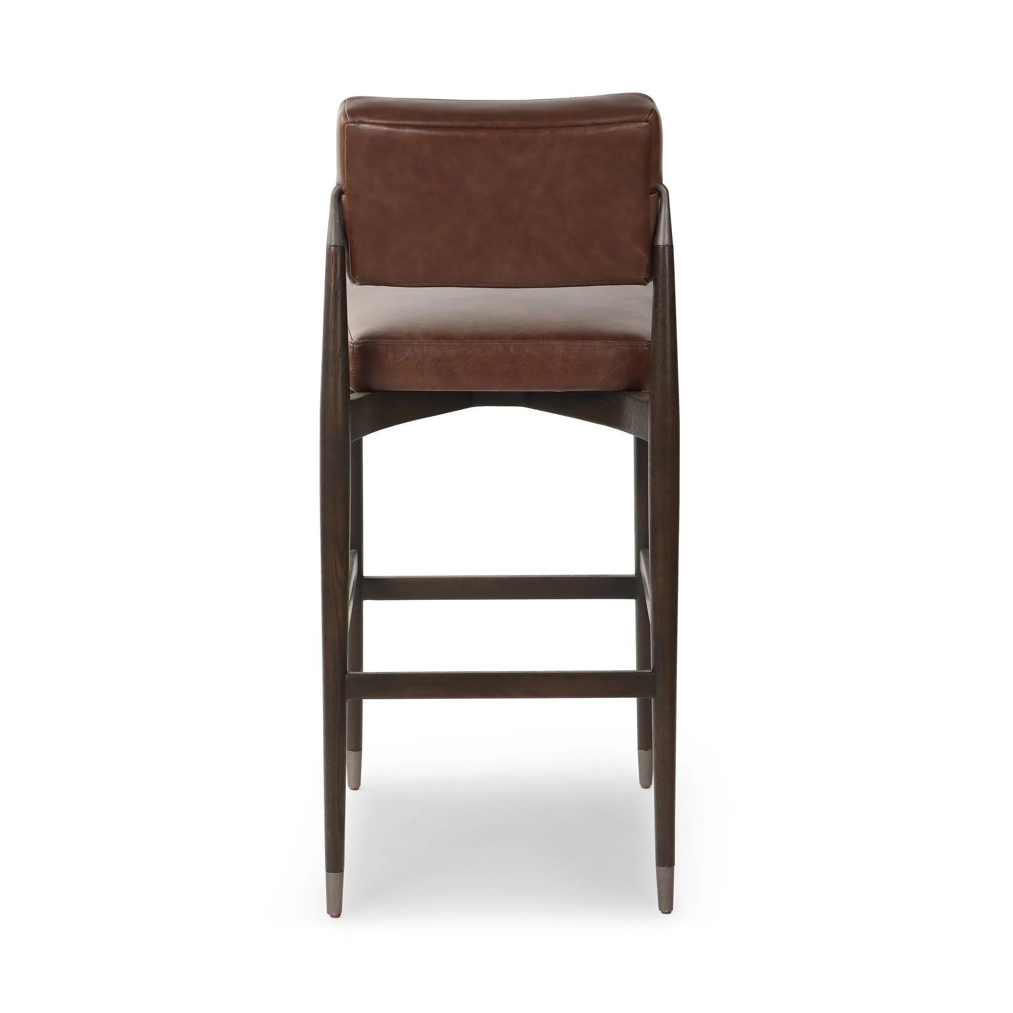 Featuring Anton Havana Brown  Bar + Counter Stool by Four Hands at Amethyst Home. Eighties inspiration gone modern. With iron-dipped caps, tapered legs of solid oak frame this counter stool's seat and back, upholstered in brown top-grain leather. Slim wood stretchers add an airy vibe.BarOverall Dimensions: 20.00"w x 23.75"d x 42.75"hWeight: 18.08 lbsCounter. Amethyst Home provides interior design, new home construction design consulting, vintage area rugs, and lighting in the Calabasas metro area.