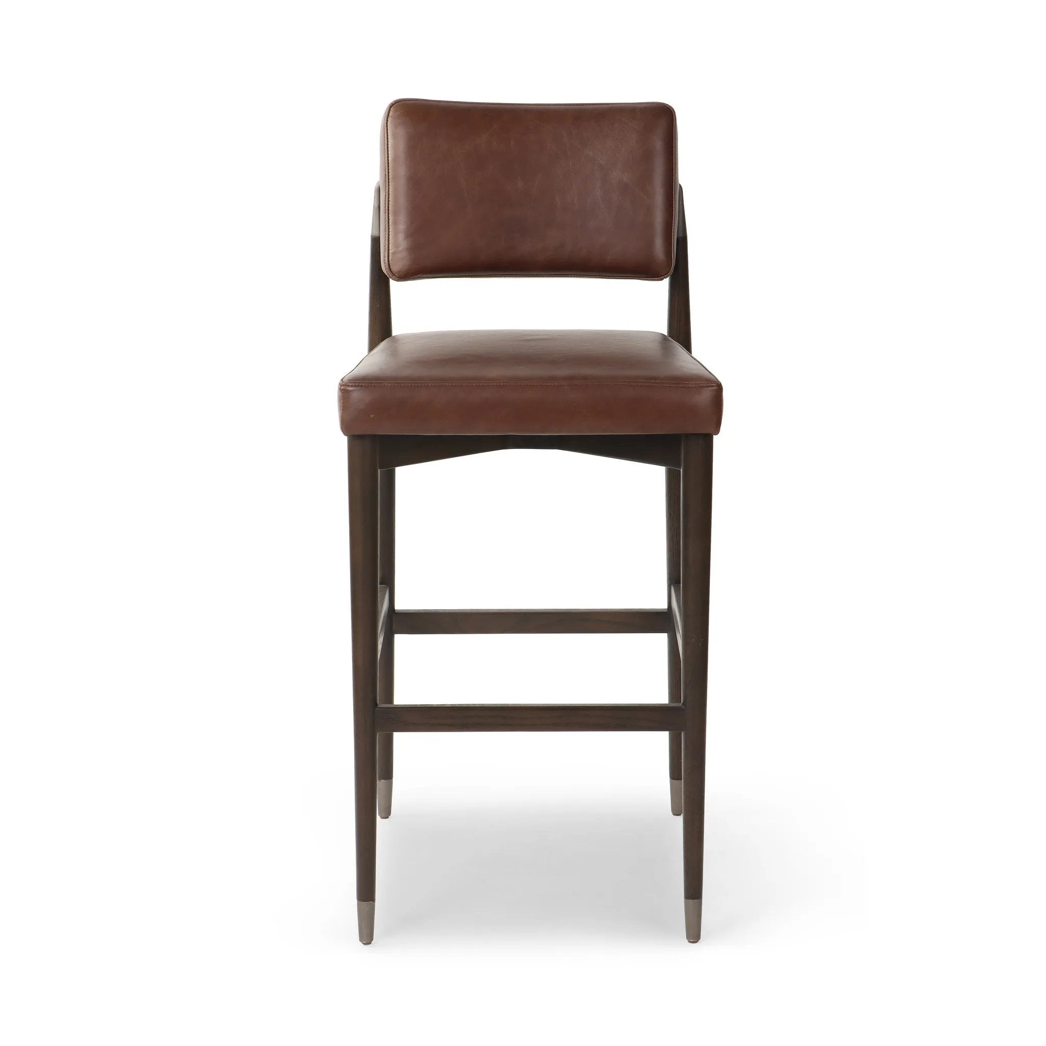 Featuring Anton Havana Brown  Bar + Counter Stool by Four Hands at Amethyst Home. Eighties inspiration gone modern. With iron-dipped caps, tapered legs of solid oak frame this counter stool's seat and back, upholstered in brown top-grain leather. Slim wood stretchers add an airy vibe.BarOverall Dimensions: 20.00"w x 23.75"d x 42.75"hWeight: 18.08 lbsCounter. Amethyst Home provides interior design, new home construction design consulting, vintage area rugs, and lighting in the Charlotte metro area.
