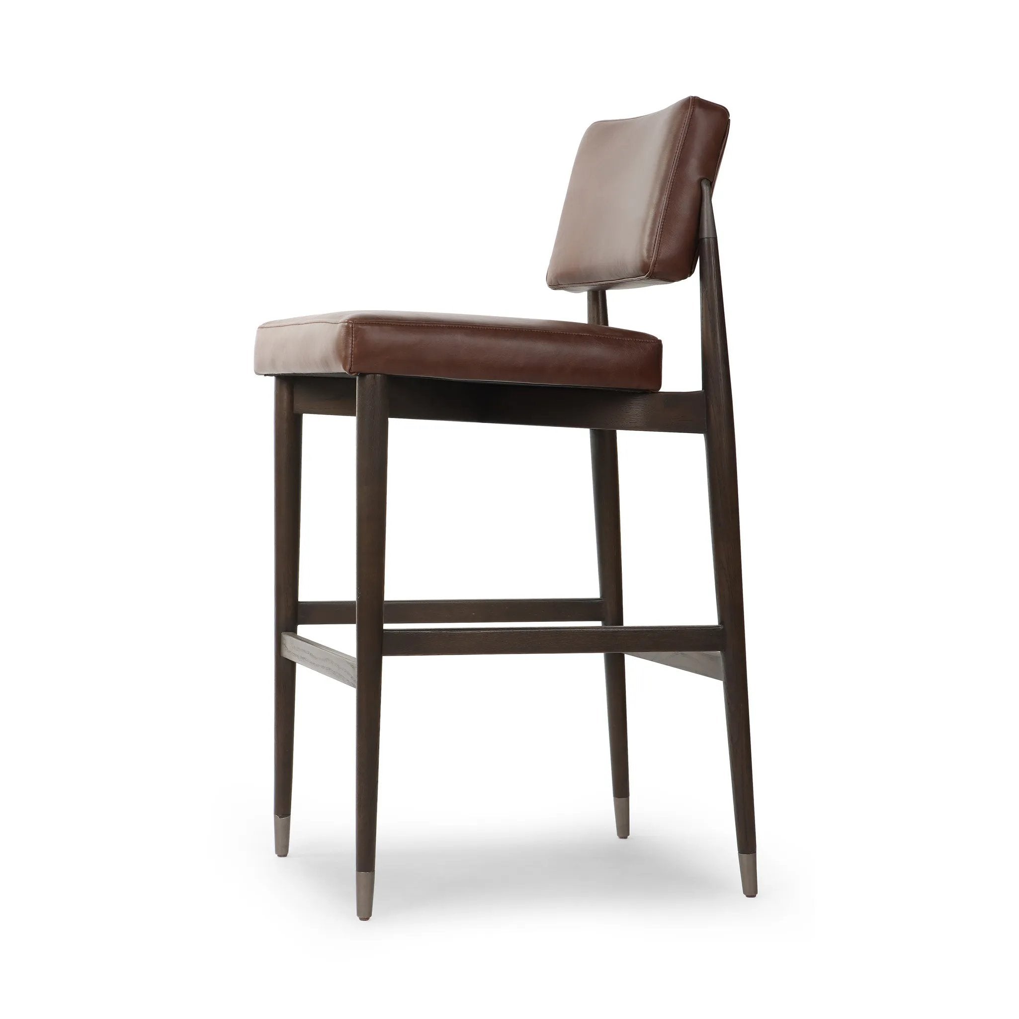 Featuring Anton Havana Brown  Bar + Counter Stool by Four Hands at Amethyst Home. Eighties inspiration gone modern. With iron-dipped caps, tapered legs of solid oak frame this counter stool's seat and back, upholstered in brown top-grain leather. Slim wood stretchers add an airy vibe.BarOverall Dimensions: 20.00"w x 23.75"d x 42.75"hWeight: 18.08 lbsCo. Amethyst Home provides interior design, new home construction design consulting, vintage area rugs, and lighting in the Salt Lake City metro area.