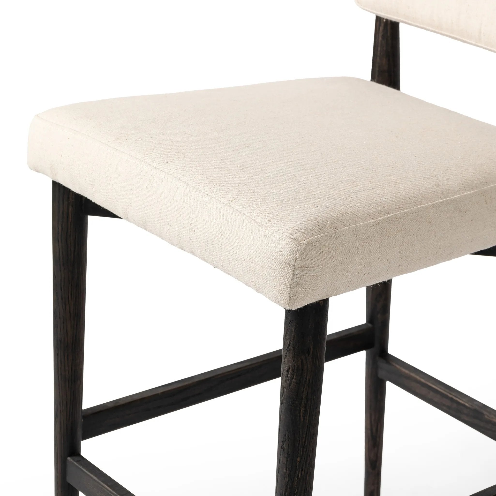 Featuring Anton Savile Flax Bar + Counter Stool by Four Hands at Amethyst Home. Eighties inspiration gone modern. With iron-dipped caps, tapered legs of solid oak frame this bar stool's seat and back, upholstered in light performance fabric. Slim wood stretchers add an airy vibe to this counter stool. Performance fabrics are specially created to withstand . Amethyst Home provides interior design, new home construction design consulting, vintage area rugs, and lighting in the Alpharetta metro area.