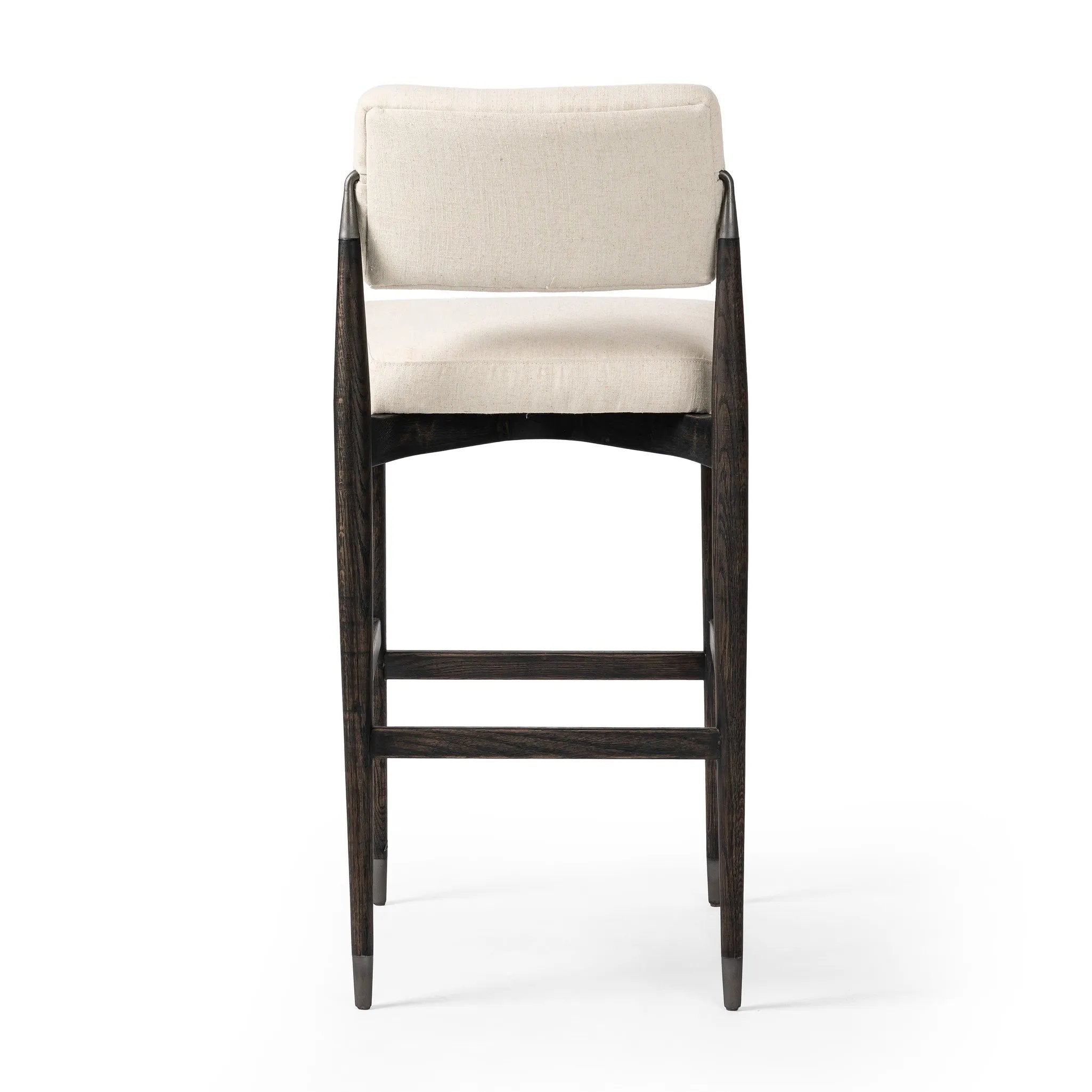 Featuring Anton Savile Flax Bar + Counter Stool by Four Hands at Amethyst Home. Eighties inspiration gone modern. With iron-dipped caps, tapered legs of solid oak frame this bar stool's seat and back, upholstered in light performance fabric. Slim wood stretchers add an airy vibe to this counter stool. Performance fabrics are specially created to withstand s. Amethyst Home provides interior design, new home construction design consulting, vintage area rugs, and lighting in the Calabasas metro area.