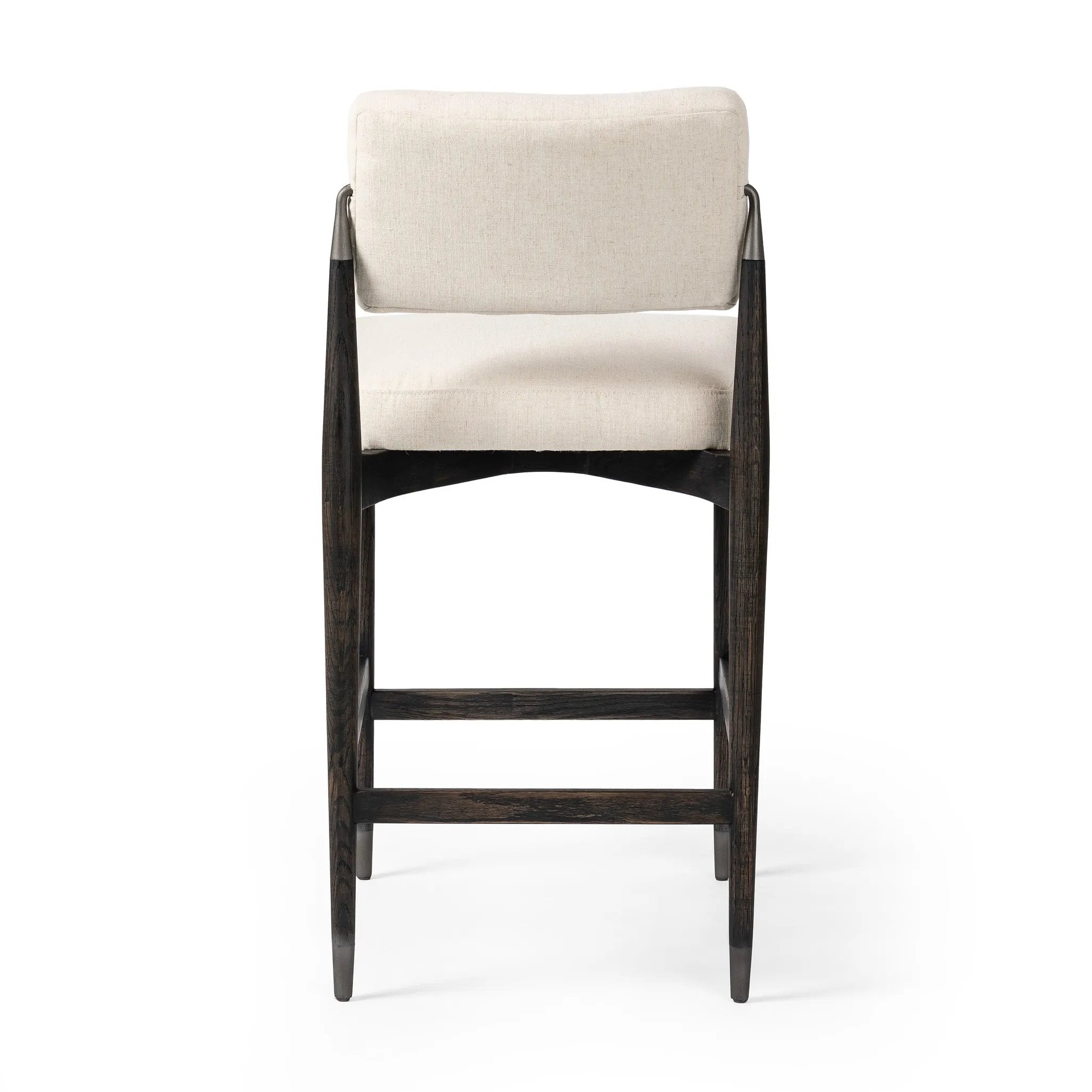Featuring Anton Savile Flax Bar + Counter Stool by Four Hands at Amethyst Home. Eighties inspiration gone modern. With iron-dipped caps, tapered legs of solid oak frame this bar stool's seat and back, upholstered in light performance fabric. Slim wood stretchers add an airy vibe to this counter stool. Performance fabrics are specially created to withstand s. Amethyst Home provides interior design, new home construction design consulting, vintage area rugs, and lighting in the Nashville metro area.