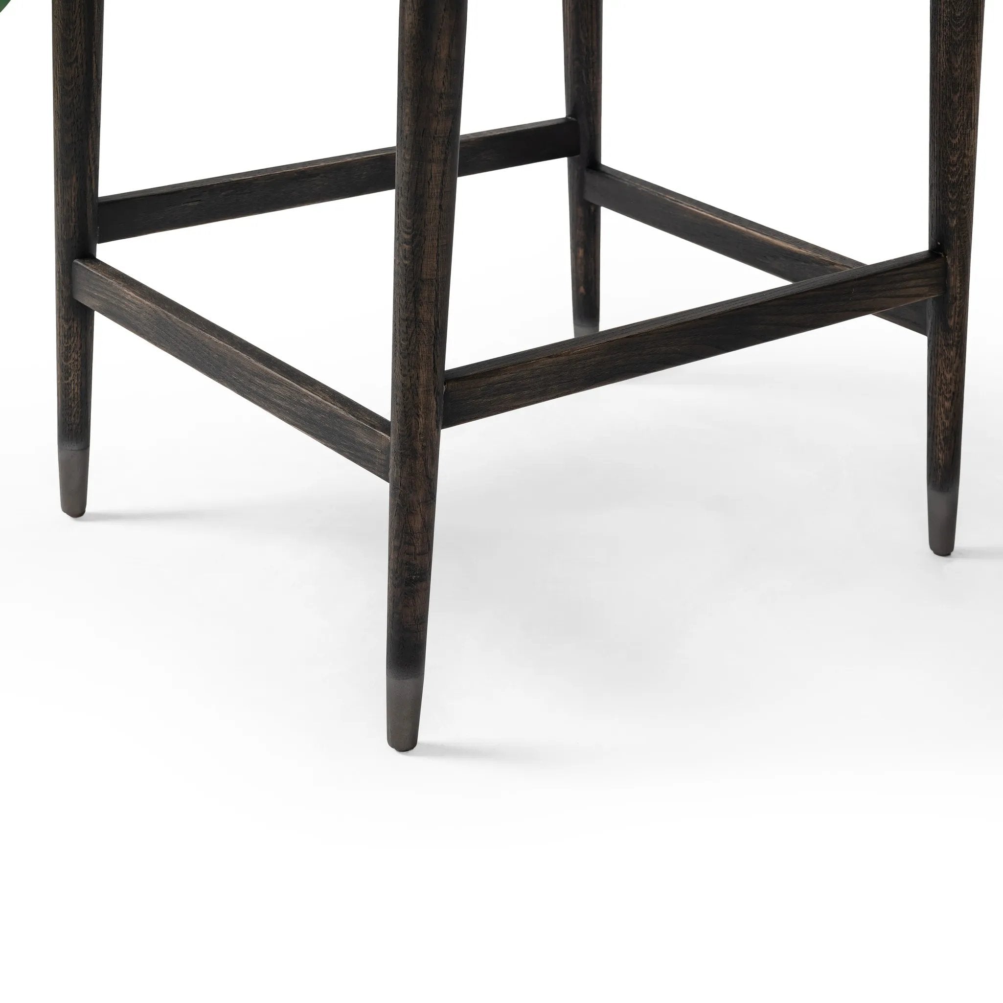 Featuring Anton Savile Flax Bar + Counter Stool by Four Hands at Amethyst Home. Eighties inspiration gone modern. With iron-dipped caps, tapered legs of solid oak frame this bar stool's seat and back, upholstered in light performance fabric. Slim wood stretchers add an airy vibe to this counter stool. Performance fabrics are specially created to withstand spill. Amethyst Home provides interior design, new home construction design consulting, vintage area rugs, and lighting in the Omaha metro area.
