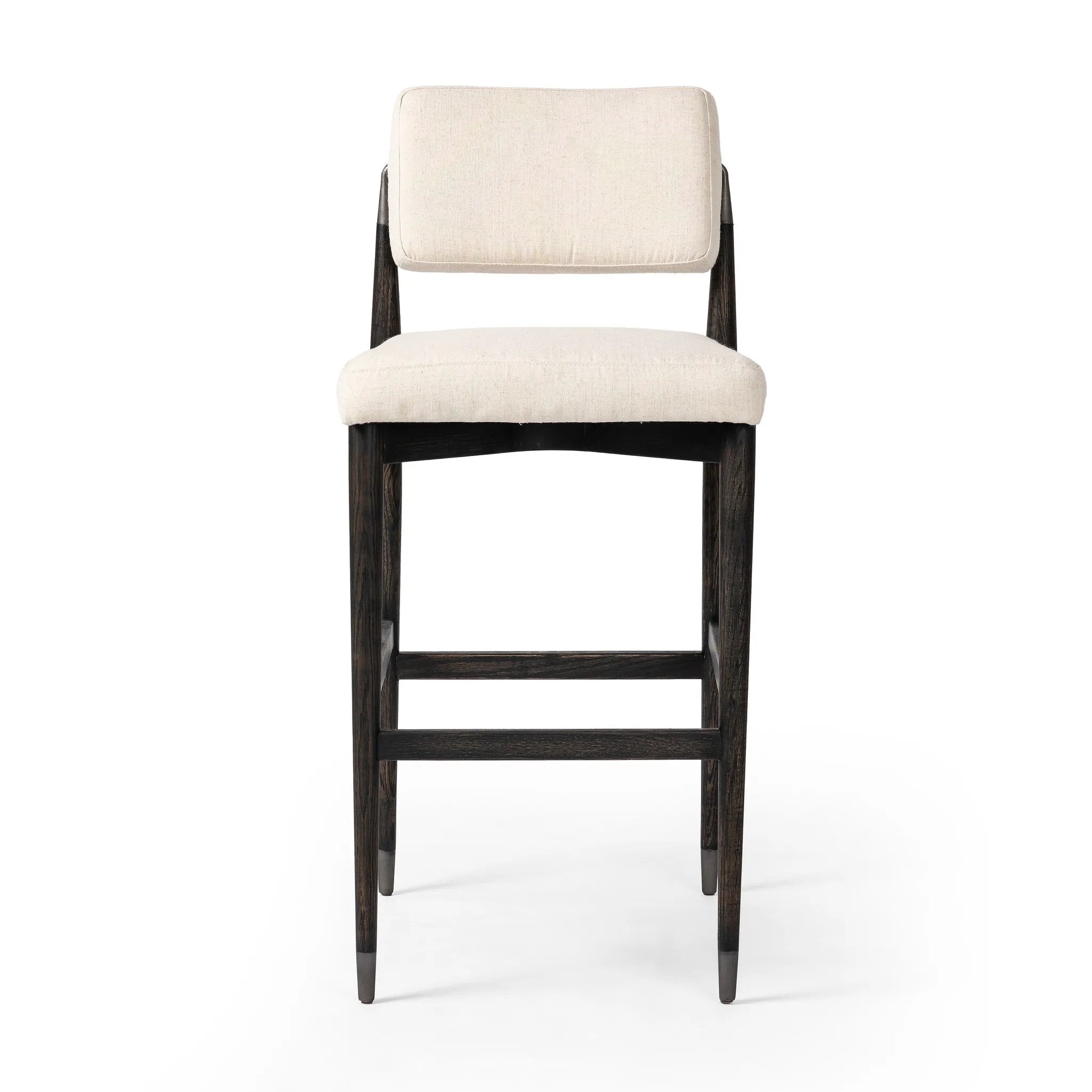 Featuring Anton Savile Flax Bar + Counter Stool by Four Hands at Amethyst Home. Eighties inspiration gone modern. With iron-dipped caps, tapered legs of solid oak frame this bar stool's seat and back, upholstered in light performance fabric. Slim wood stretchers add an airy vibe to this counter stool. Performance fabrics are specially created to withstand . Amethyst Home provides interior design, new home construction design consulting, vintage area rugs, and lighting in the Washington metro area.