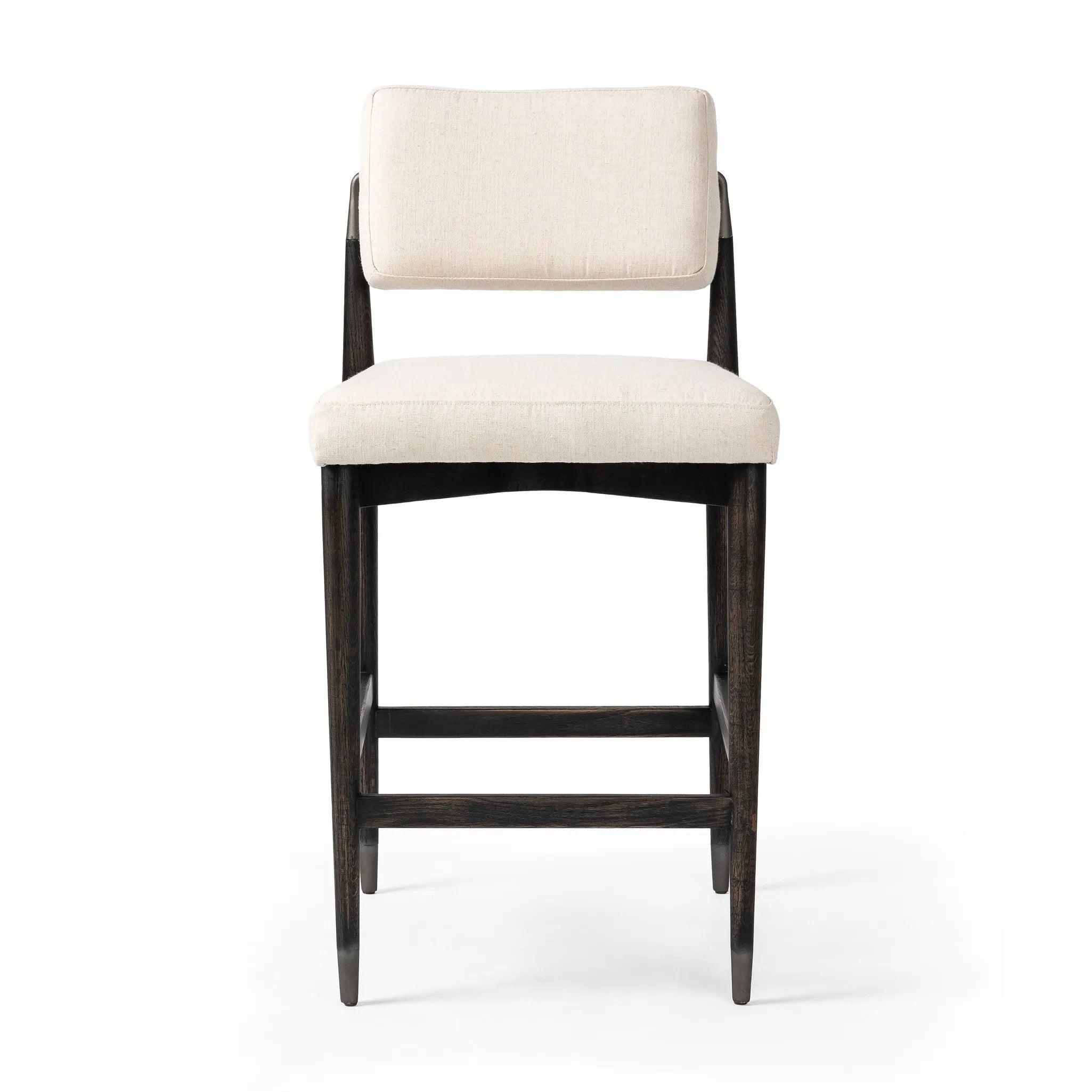 Eighties inspiration gone modern. With iron-dipped caps, tapered legs of solid oak frame this bar stool's seat and back, upholstered in light performance fabric. Slim wood stretchers add an airy vibe to this counter stool. Amethyst Home provides interior design, new home construction design consulting, vintage area rugs, and lighting in the Winter Garden metro area.