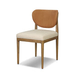 Midcentury meets organic modernism in this mixed-material dining chair. A top-grain leather seat back pairs with a cushioned seat upholstered in performance fabric, with stitch detailing along the seat back. All framed by solid oak finished in a warm amber. Amethyst Home provides interior design, new home construction design consulting, vintage area rugs, and lighting in the Boston metro area.