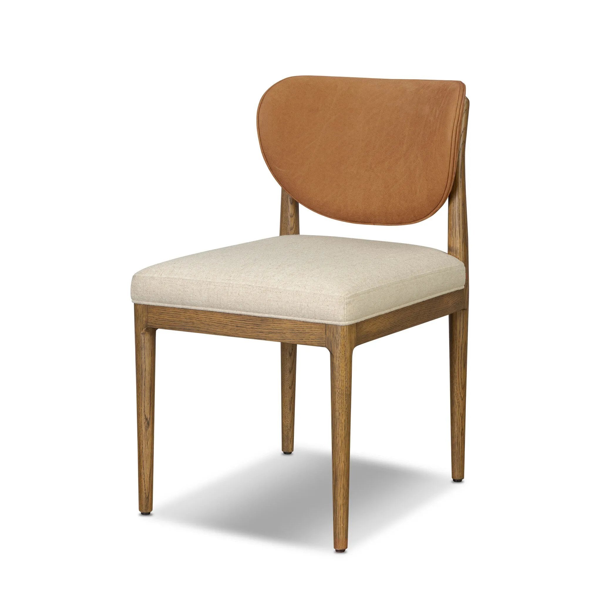 Midcentury meets organic modernism in this mixed-material dining chair. A top-grain leather seat back pairs with a cushioned seat upholstered in performance fabric, with stitch detailing along the seat back. All framed by solid oak finished in a warm amber. Amethyst Home provides interior design, new home construction design consulting, vintage area rugs, and lighting in the Boston metro area.