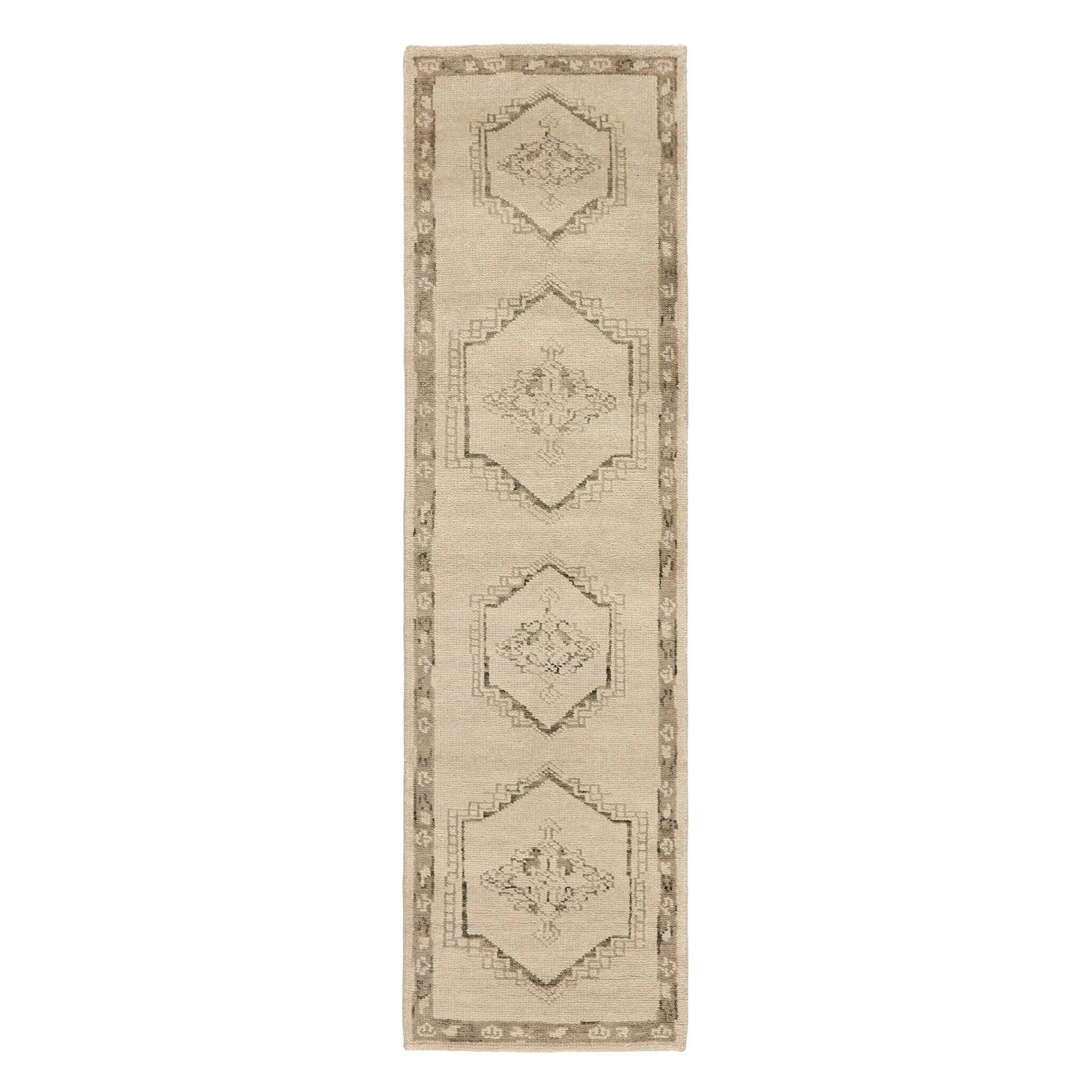 Patterned with a simplistic three-emblem motif framed by a narrow border, this hand-knotted wool rug adds just a touch of neutral design. The durable runner is crafted to wear beautifully over time. Due to the handcrafted nature of this rug, slight variations in sizing may occur Amethyst Home provides interior design, new home construction design consulting, vintage area rugs, and lighting in the San Diego metro area.