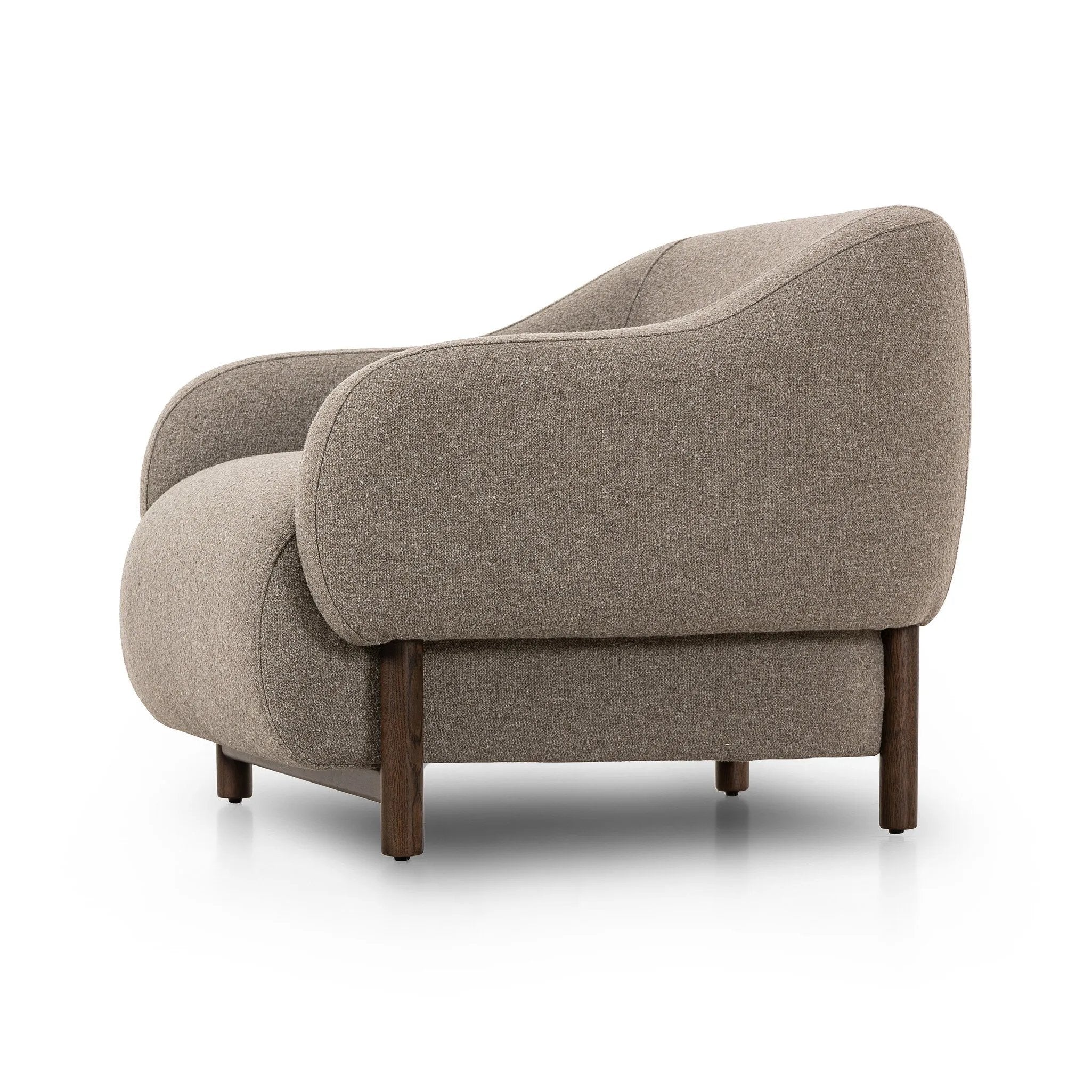 Featuring Audrey Weslie Feather Chair by Four Hands at Amethyst Home. This elevated arm chair features a clean top piece that partially overlaps its bottom counterpart and seamlessly blends the back cushion into the armrests in one fluid form. The seat's legs appear to extend from the seat and back, adding architectural interest. Upholstered in a recycled Turk. Amethyst Home provides interior design, new home construction design consulting, vintage area rugs, and lighting in the Boston metro area.