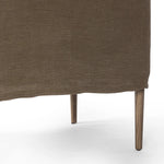 Heritage-inspired comfort. Sloping track arms are a study in playful forms, while the frame's fluid shape creates a simple, polished look. Tapered legs extend beyond a short skirt for a more relaxed style. Covered in 100% linen. A design collaboration by Amber Lewis and Four Hands. Amethyst Home provides interior design, new home construction design consulting, vintage area rugs, and lighting in the Laguna Beach metro area.