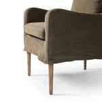 Heritage-inspired comfort. Sloping track arms are a study in playful forms, while the frame's fluid shape creates a simple, polished look. Tapered legs extend beyond a short skirt for a more relaxed style. Covered in 100% linen. A design collaboration by Amber Lewis and Four Hands. Amethyst Home provides interior design, new home construction design consulting, vintage area rugs, and lighting in the Portland metro area.