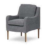 Heritage-inspired comfort. Sloping track arms are a study in playful forms, while the frame's fluid shape creates a simple, polished look. Tapered legs extend beyond a short skirt for a more relaxed style. Covered in 100% linen. A design collaboration by Amber Lewis and Four Hands. Amethyst Home provides interior design, new home construction design consulting, vintage area rugs, and lighting in the Calabasas metro area.