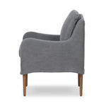 Heritage-inspired comfort. Sloping track arms are a study in playful forms, while the frame's fluid shape creates a simple, polished look. Tapered legs extend beyond a short skirt for a more relaxed style. Covered in 100% linen. A design collaboration by Amber Lewis and Four Hands. Amethyst Home provides interior design, new home construction design consulting, vintage area rugs, and lighting in the Scottsdale metro area.
