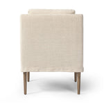 Heritage-inspired comfort. Sloping track arms are a study in playful forms, while the frame's fluid shape creates a simple, polished look. Tapered legs extend beyond a short skirt for a more relaxed style. Covered in 100% linen. A design collaboration by Amber Lewis and Four Hands. Amethyst Home provides interior design, new home construction design consulting, vintage area rugs, and lighting in the Alpharetta metro area.