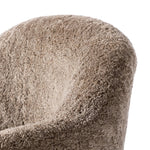 Intriguing while inviting, drum-style seating is upholstered in a soft, taupe shearling. A 360-degree swivel base of natural parawood places a fresh spin on a feminine form Amethyst Home provides interior design, new home construction design consulting, vintage area rugs, and lighting in the Charlotte metro area.
