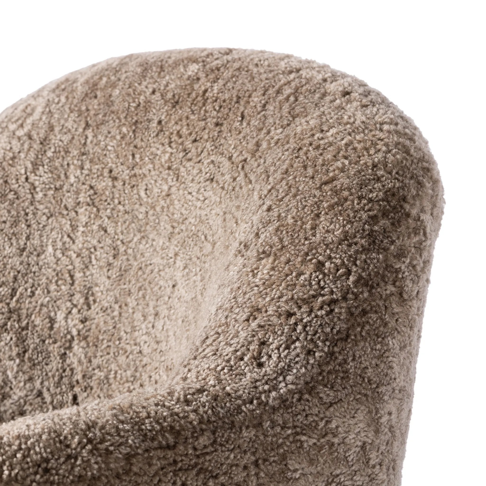 Intriguing while inviting, drum-style seating is upholstered in a soft, taupe shearling. A 360-degree swivel base of natural parawood places a fresh spin on a feminine form Amethyst Home provides interior design, new home construction design consulting, vintage area rugs, and lighting in the Charlotte metro area.