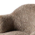 Intriguing while inviting, drum-style seating is upholstered in a soft, taupe shearling. A 360-degree swivel base of natural parawood places a fresh spin on a feminine form Amethyst Home provides interior design, new home construction design consulting, vintage area rugs, and lighting in the Los Angeles metro area.