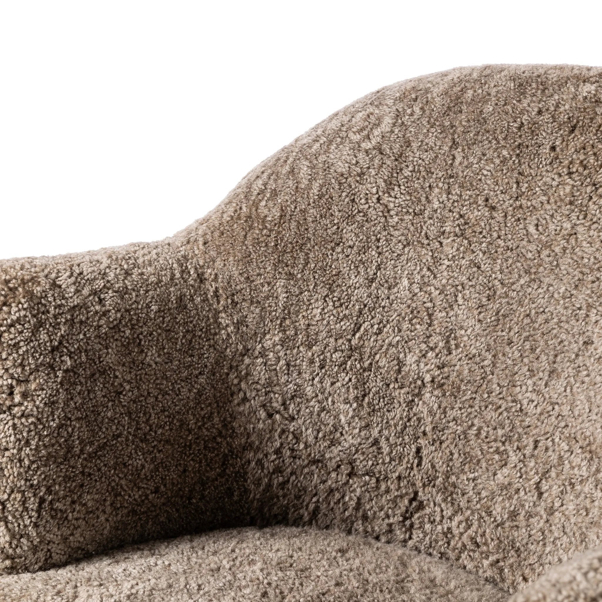 Intriguing while inviting, drum-style seating is upholstered in a soft, taupe shearling. A 360-degree swivel base of natural parawood places a fresh spin on a feminine form Amethyst Home provides interior design, new home construction design consulting, vintage area rugs, and lighting in the Los Angeles metro area.