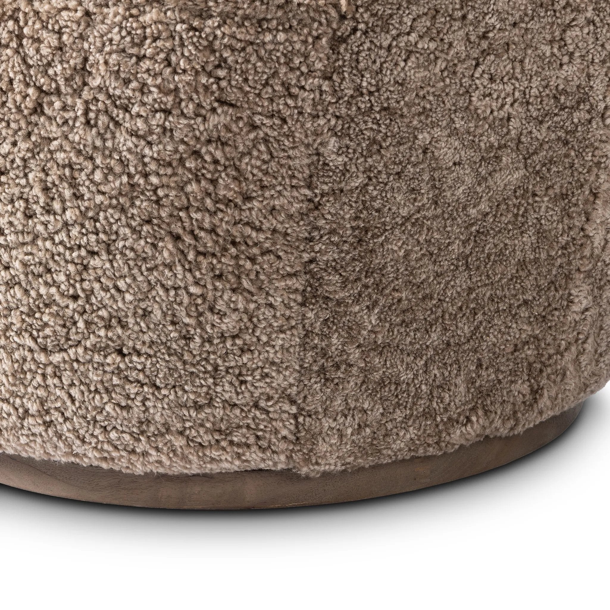 Intriguing while inviting, drum-style seating is upholstered in a soft, taupe shearling. A 360-degree swivel base of natural parawood places a fresh spin on a feminine form Amethyst Home provides interior design, new home construction design consulting, vintage area rugs, and lighting in the Park City metro area.