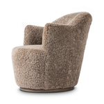 Intriguing while inviting, drum-style seating is upholstered in a soft, taupe shearling. A 360-degree swivel base of natural parawood places a fresh spin on a feminine form Amethyst Home provides interior design, new home construction design consulting, vintage area rugs, and lighting in the Tampa metro area.