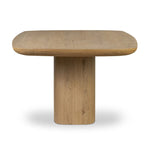 A stately dining style inspired by soft Brutalism. Crafted from aged smoked oak, a pair of matching pedestal bases features a delicate break between them, bringing a touch of lightness to such a substantial piece. A wide rectangular tabletop shapes arched sides that flow into rounded corners, finished off with bullnose edging Amethyst Home provides interior design, new home construction design consulting, vintage area rugs, and lighting in the Los Angeles metro area.