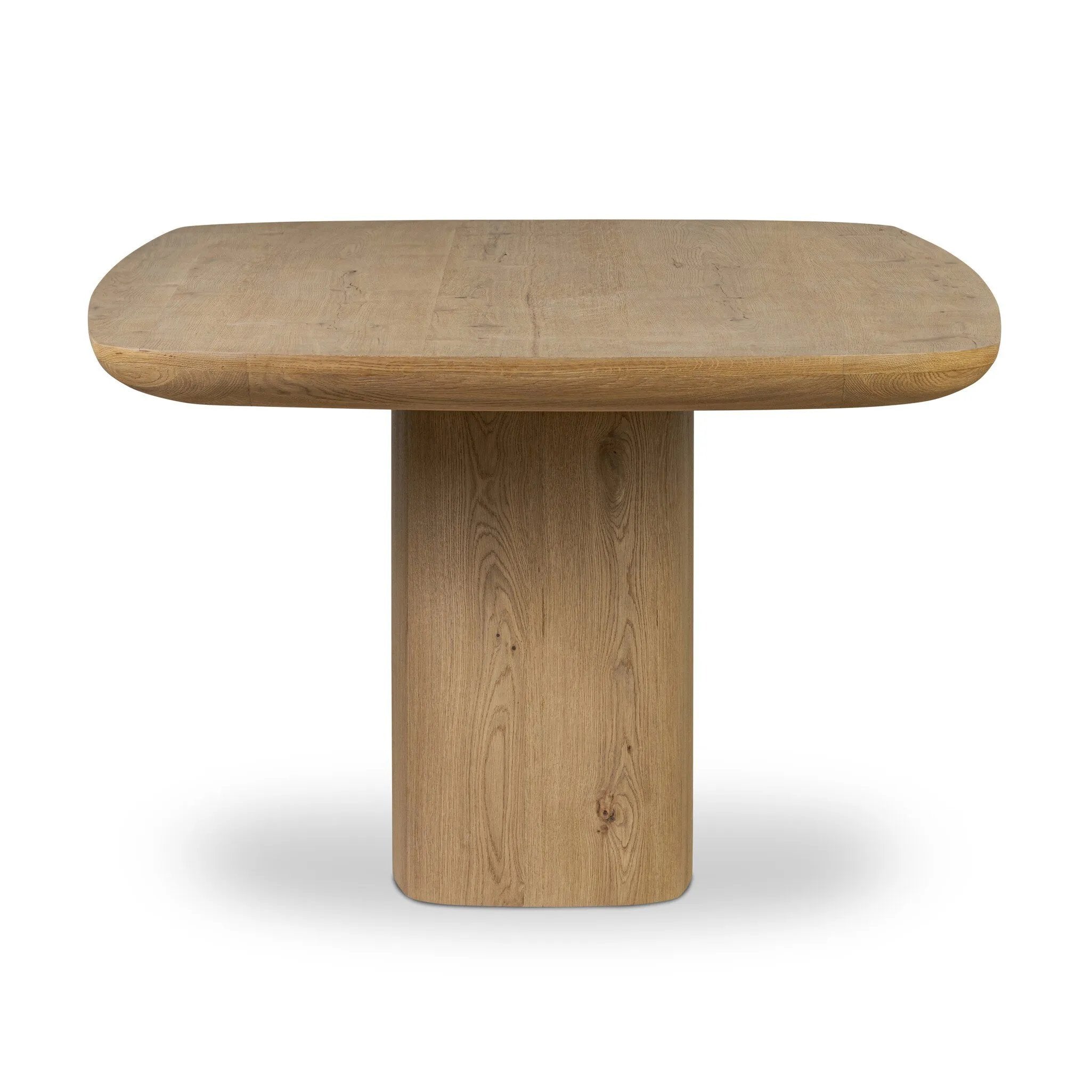 A stately dining style inspired by soft Brutalism. Crafted from aged smoked oak, a pair of matching pedestal bases features a delicate break between them, bringing a touch of lightness to such a substantial piece. A wide rectangular tabletop shapes arched sides that flow into rounded corners, finished off with bullnose edging Amethyst Home provides interior design, new home construction design consulting, vintage area rugs, and lighting in the Los Angeles metro area.