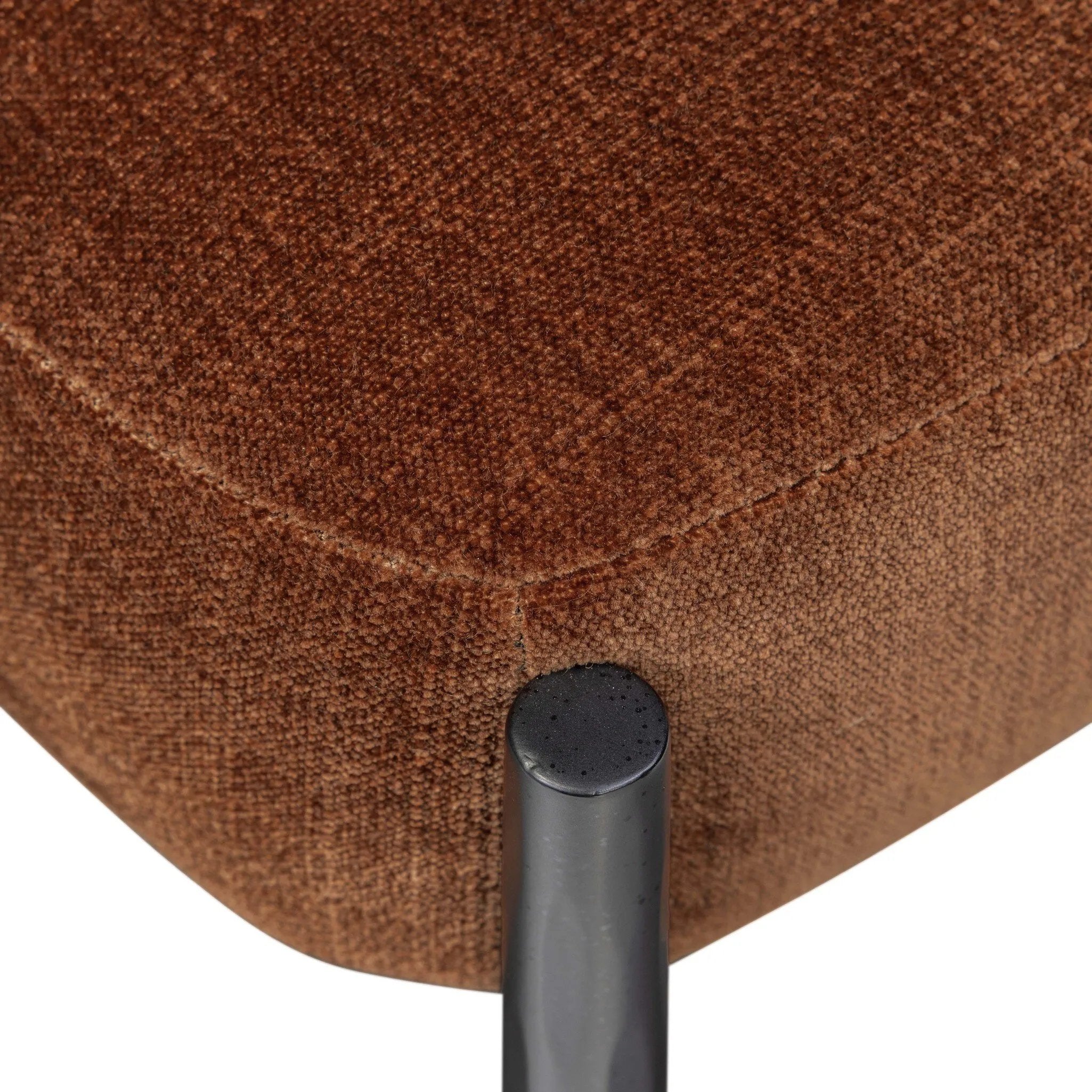 Bring a refreshed midcentury look — and pop of color — to your table. Comfortable seat and back cushions are upholstered in a velvety fabric with a soft, chenille-like feel, while slim, black-finished iron frame curves at the top to soften things up. Simple tapered legs complete the look. Amethyst Home provides interior design, new home construction design consulting, vintage area rugs, and lighting in the Dallas metro area.