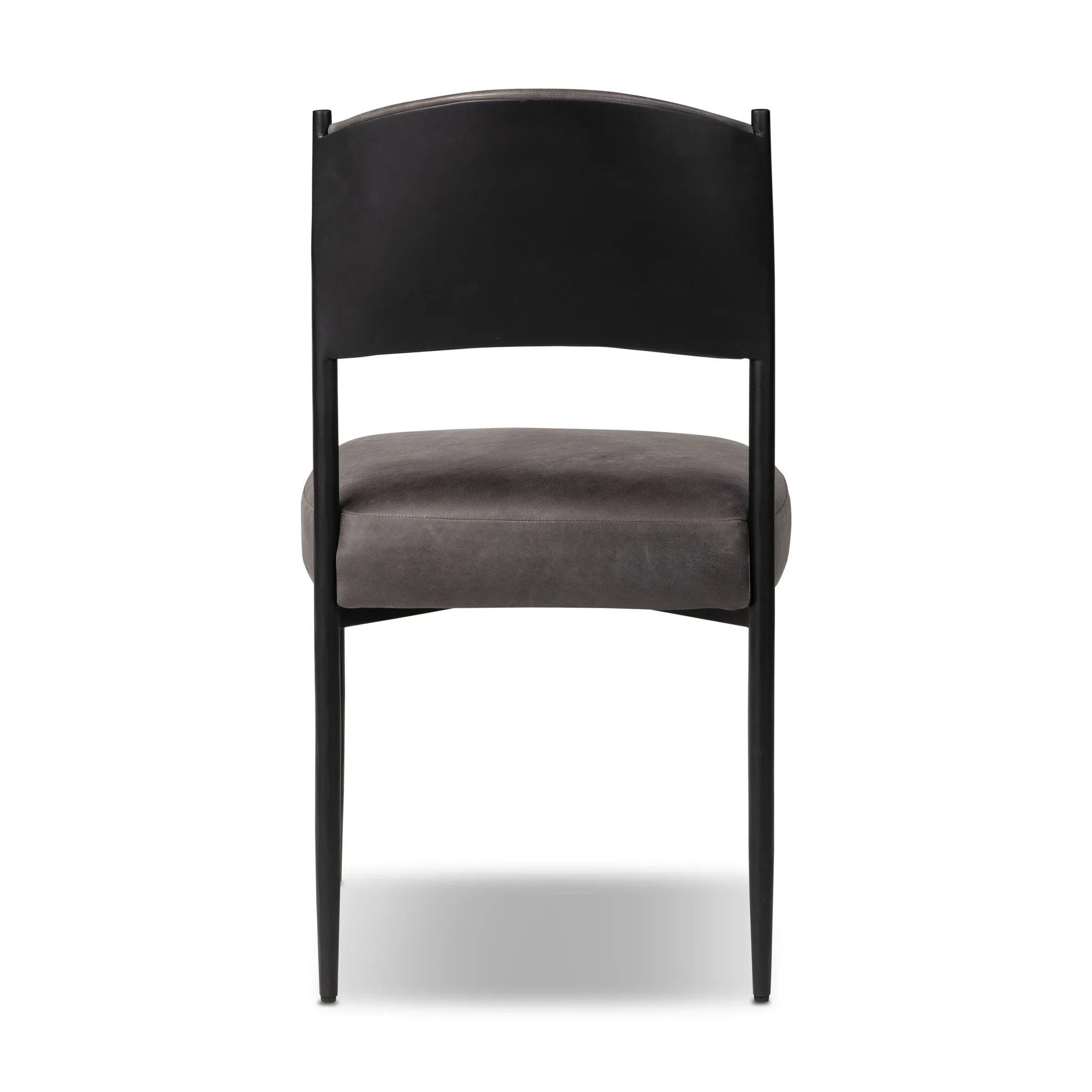 Bring a refreshed midcentury look to your table. Comfortable seat and back cushions are upholstered in a black top-grain leather, with a slim iron frame curving at the top to soften things up. Simple tapered legs complete the look.As enthusiasts of natural aesthetics at Amethyst, we love the nature inspired Bellaire Dining Chair - Palermo Black. Amethyst Home provides interior design, new home construction design consulting, vintage area rugs, and lighting in the Calabasas metro area.