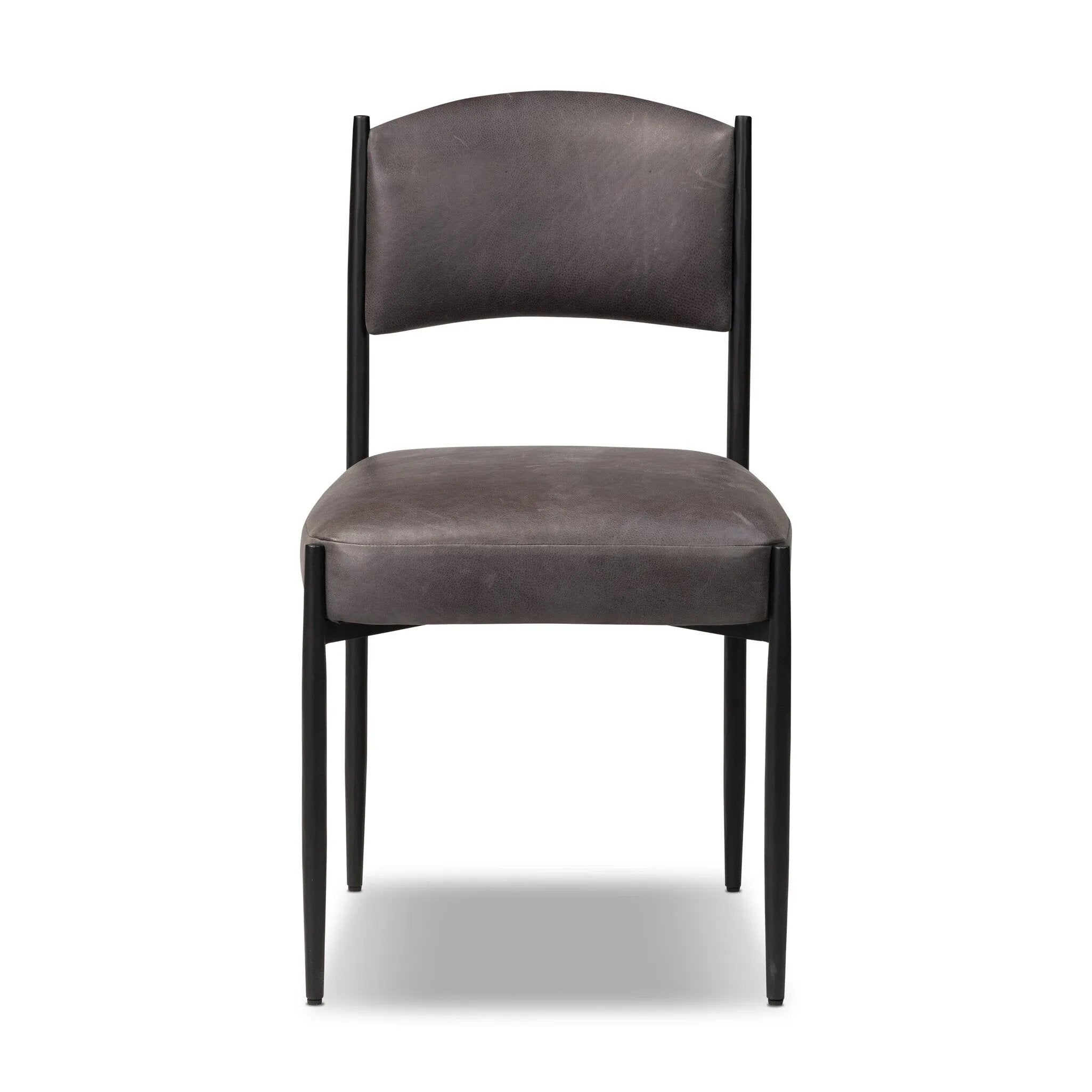Bring a refreshed midcentury look to your table. Comfortable seat and back cushions are upholstered in a black top-grain leather, with a slim iron frame curving at the top to soften things up. Simple tapered legs complete the look.As enthusiasts of natural aesthetics at Amethyst, we love the nature inspired Bellaire Dining Chair - Palermo Black. Amethyst Home provides interior design, new home construction design consulting, vintage area rugs, and lighting in the Laguna Beach metro area.