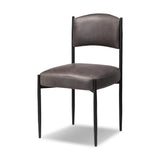 Bring a refreshed midcentury look to your table. Comfortable seat and back cushions are upholstered in a black top-grain leather, with a slim iron frame curving at the top to soften things up. Simple tapered legs complete the look.As enthusiasts of natural aesthetics at Amethyst, we love the nature inspired Bellaire Dining Chair - Palermo Black. Amethyst Home provides interior design, new home construction design consulting, vintage area rugs, and lighting in the Portland metro area.