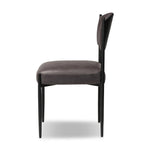Bring a refreshed midcentury look to your table. Comfortable seat and back cushions are upholstered in a black top-grain leather, with a slim iron frame curving at the top to soften things up. Simple tapered legs complete the look.As enthusiasts of natural aesthetics at Amethyst, we love the nature inspired Bellaire Dining Chair - Palermo Black. Amethyst Home provides interior design, new home construction design consulting, vintage area rugs, and lighting in the Salt Lake City metro area.