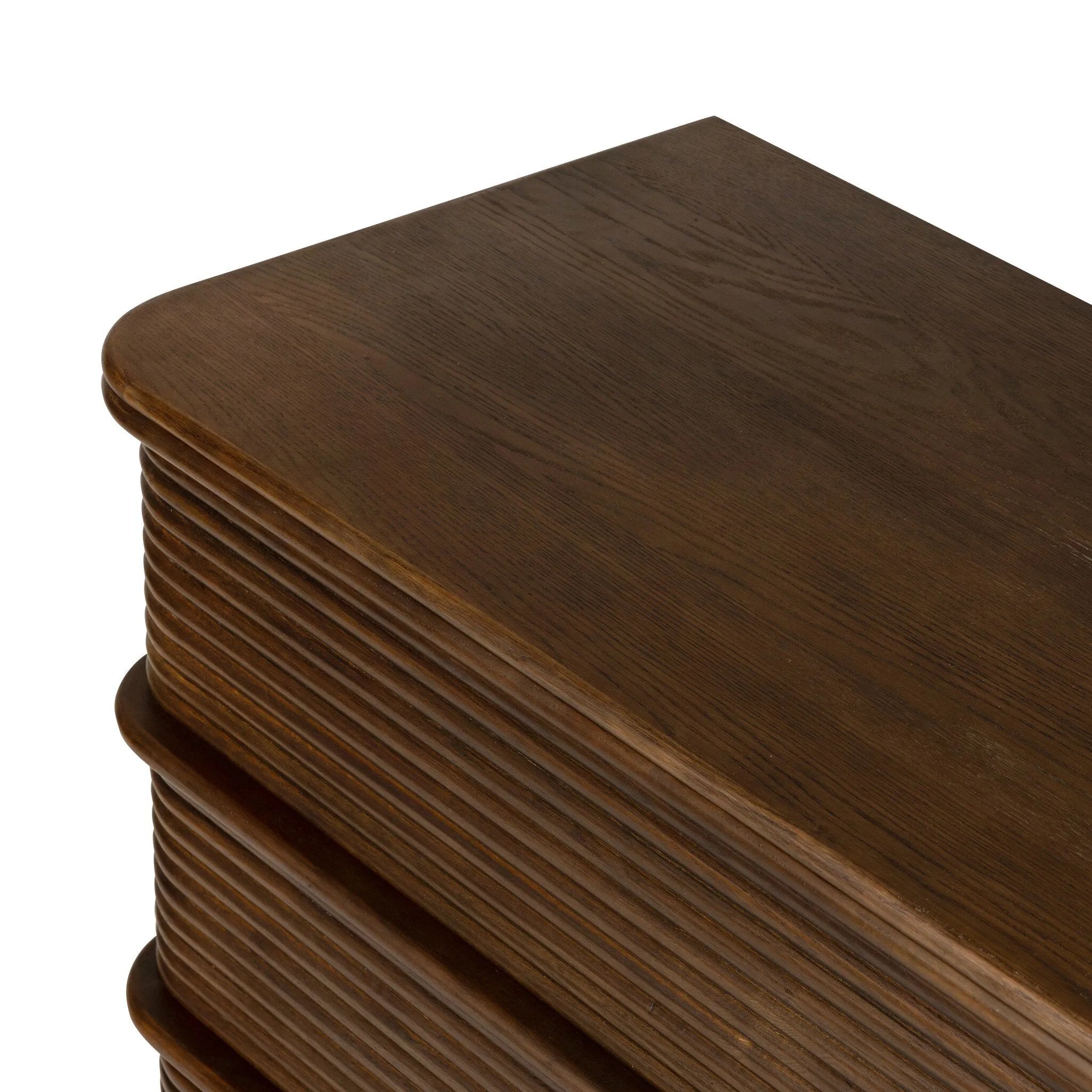 Inspired by aerodynamic-inspired Streamline Moderne style, stacked scalloped reeding wraps this spiced oak dresser with six spacious drawers. The result: a beautifully rhythmic, repeated look. With integrated hardware for a clean finish.As fans of natural materials at Amethyst, we love the nature inspired Benny 6 Drawer Dresser - Spiced Oak Veneer. Amethyst Home provides interior design, new home construction design consulting, vintage area rugs, and lighting in the Austin metro area.