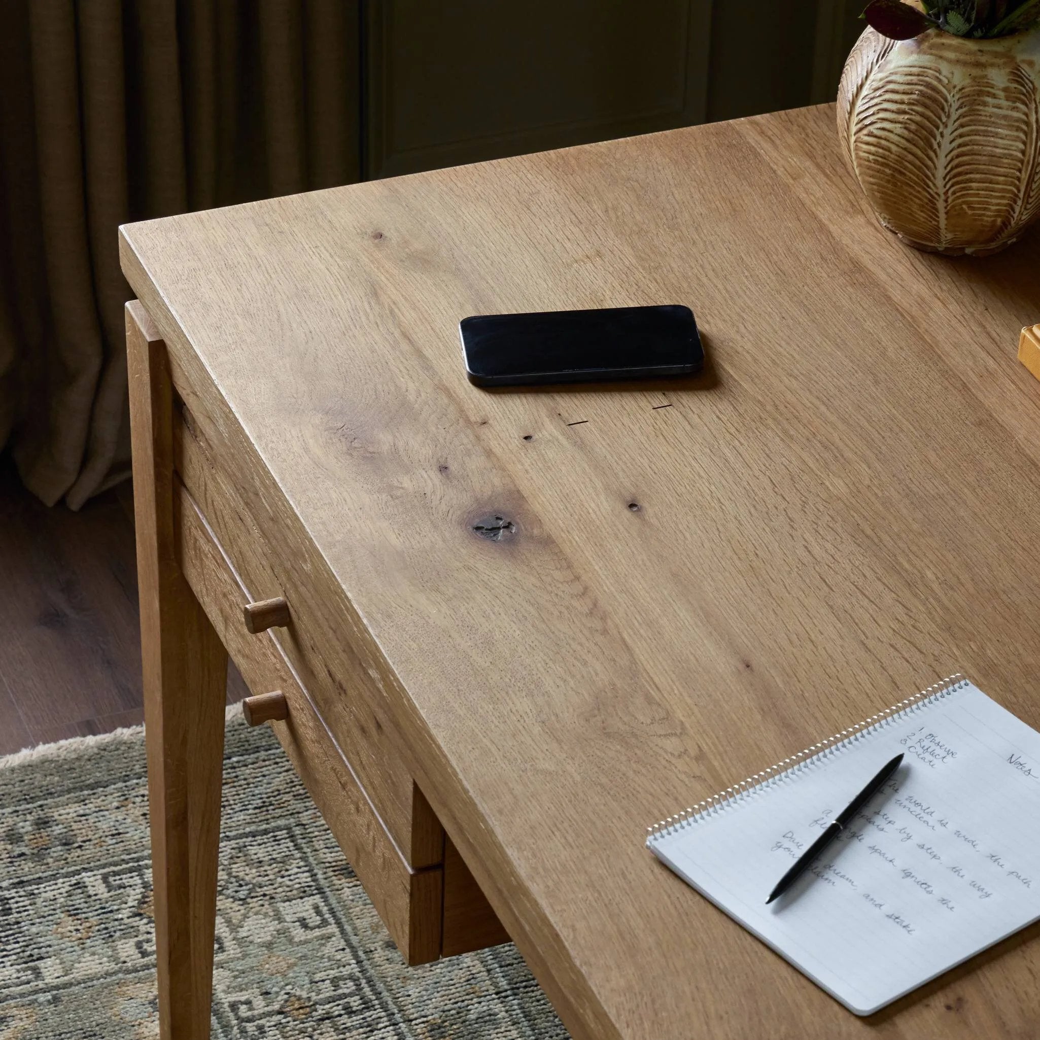 Warm up your workspace with this light-finished writing desk of rich character oak. Tapered legs and subtle corner relief details create a simplified look that complements a home office or flex space. Amethyst Home provides interior design, new home construction design consulting, vintage area rugs, and lighting in the Newport Beach metro area.