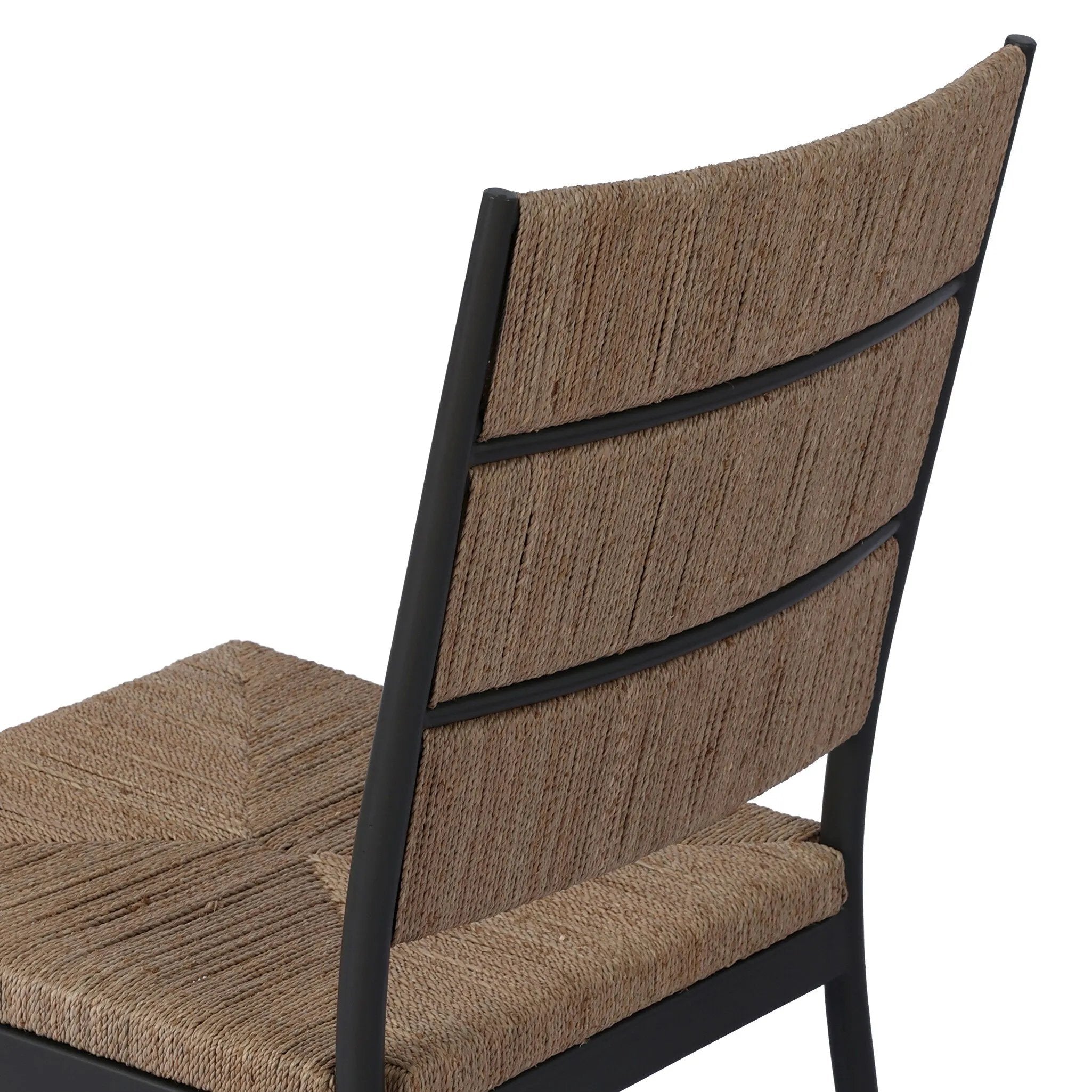 A steel dining chair frame is softened and paired with natural woven fibers. Thin, tapered legs and a tall channeled back cre