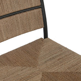 A steel dining chair frame is softened and paired with natural woven fibers. Thin, tapered legs and a tall channeled back cre